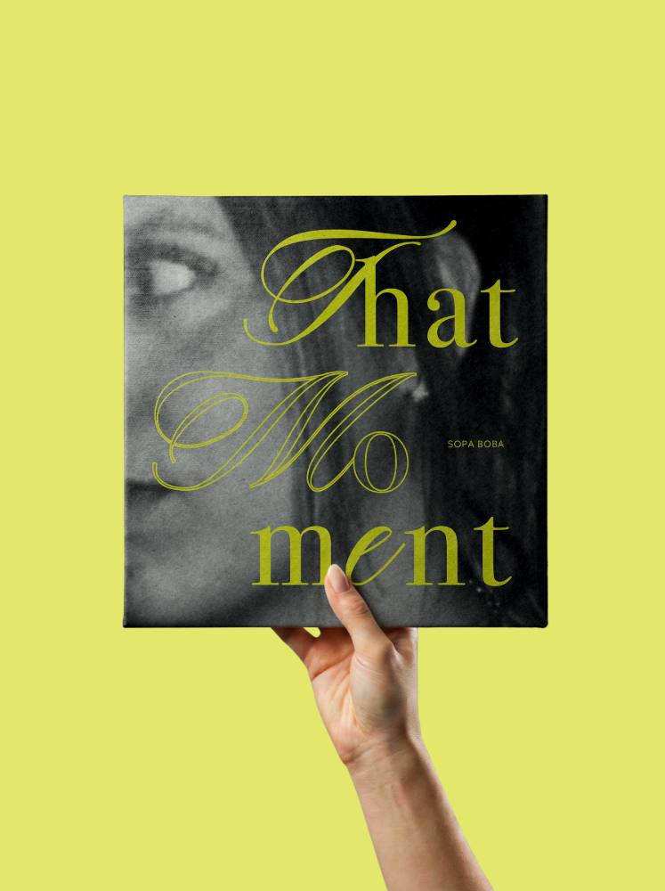 La pochette That Moment tenue à bout de bras sur fond vert acide : un portrait en noir et blanc, le titre en écriture anglaise